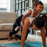 Parent working out with her child to prioritize her health.
