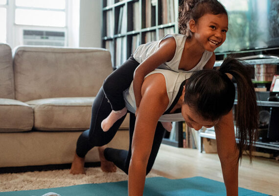 Parent working out with her child to prioritize her health.