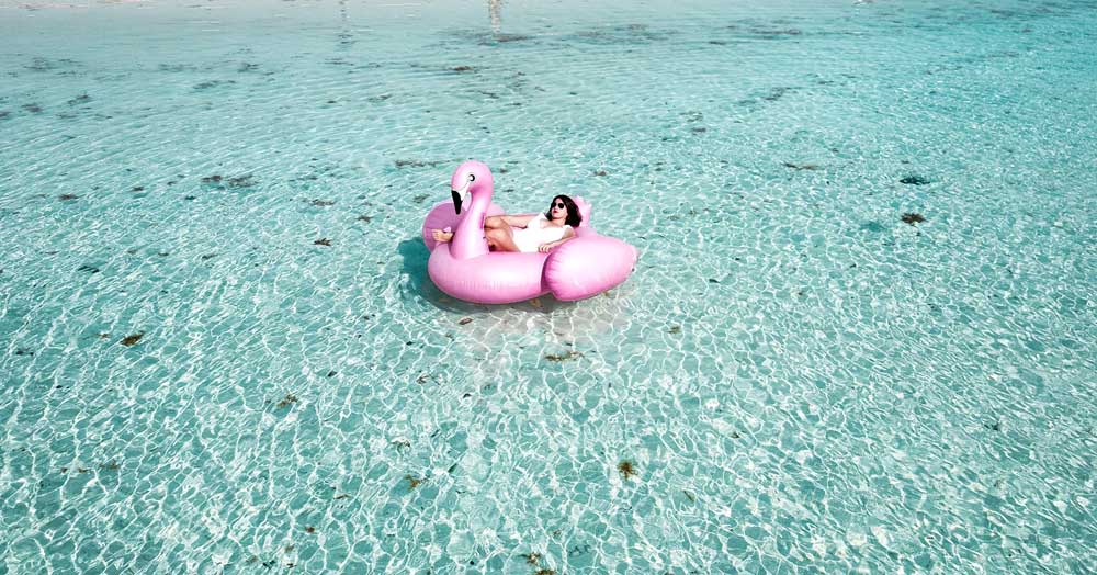 Woman enjoying her vacation floating in the sea.